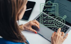 eine Frau von Hinten am Laptop, die sich damit beschäftigt, wie Fachbereiche heute planen müssen, um morgen Mitarbeitende zu gewinnen – die bleiben